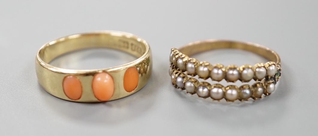 A late Victorian 15ct gold and three stone split coral set ring, size O, gross 3.3 grams and a similar yellow meta seed pearl and garnet set half hoop ring, size N, gross 1.4 grams.